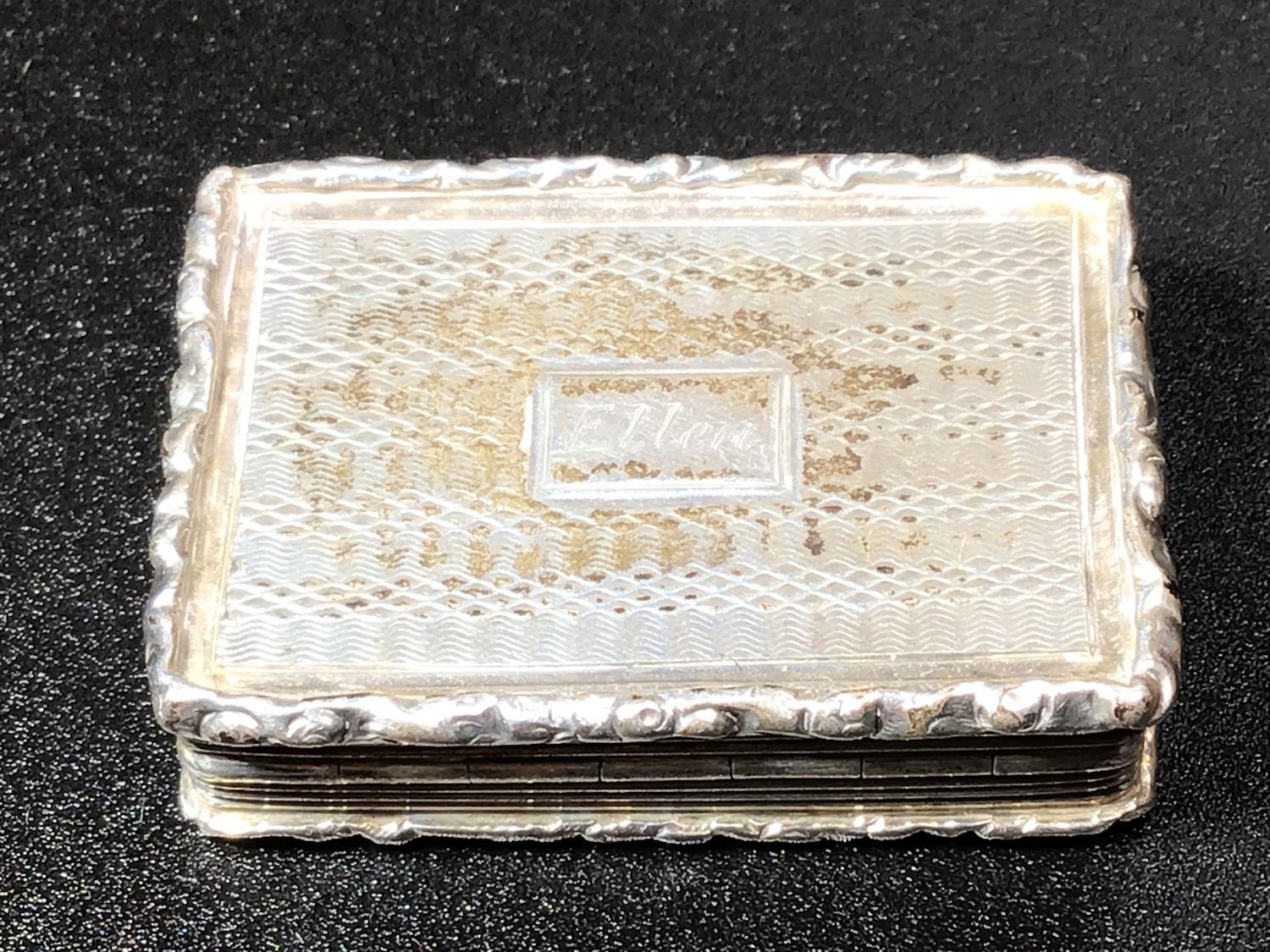 A William IV silver rectangular vinaigrette with raised borders, engine turned engraving to cover