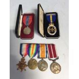 A WW1 medal trio together with a Meritorious Service Medal to H.E Sutton (Victory Medal a