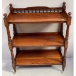 A Victorian walnut three-tier buffet with three quarter gallery to the top, on turned legs to