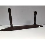 A carved hardwood ethnic weapon stand, 74cm long