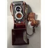 A German Rolleiflex Synchro - Compur X camera, no. 2319592, in brown leather case with flash and