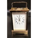 A French brass cased carriage clock, with bevelled glass front, back and sides, open platform