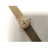 A ladies 9ct gold Omega automatic wristwatch, the silvered dial with batons denoting hours and