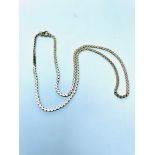 A 9ct gold serpentine link chain, measuring 18 inches in length, weighing 9.2 grams.