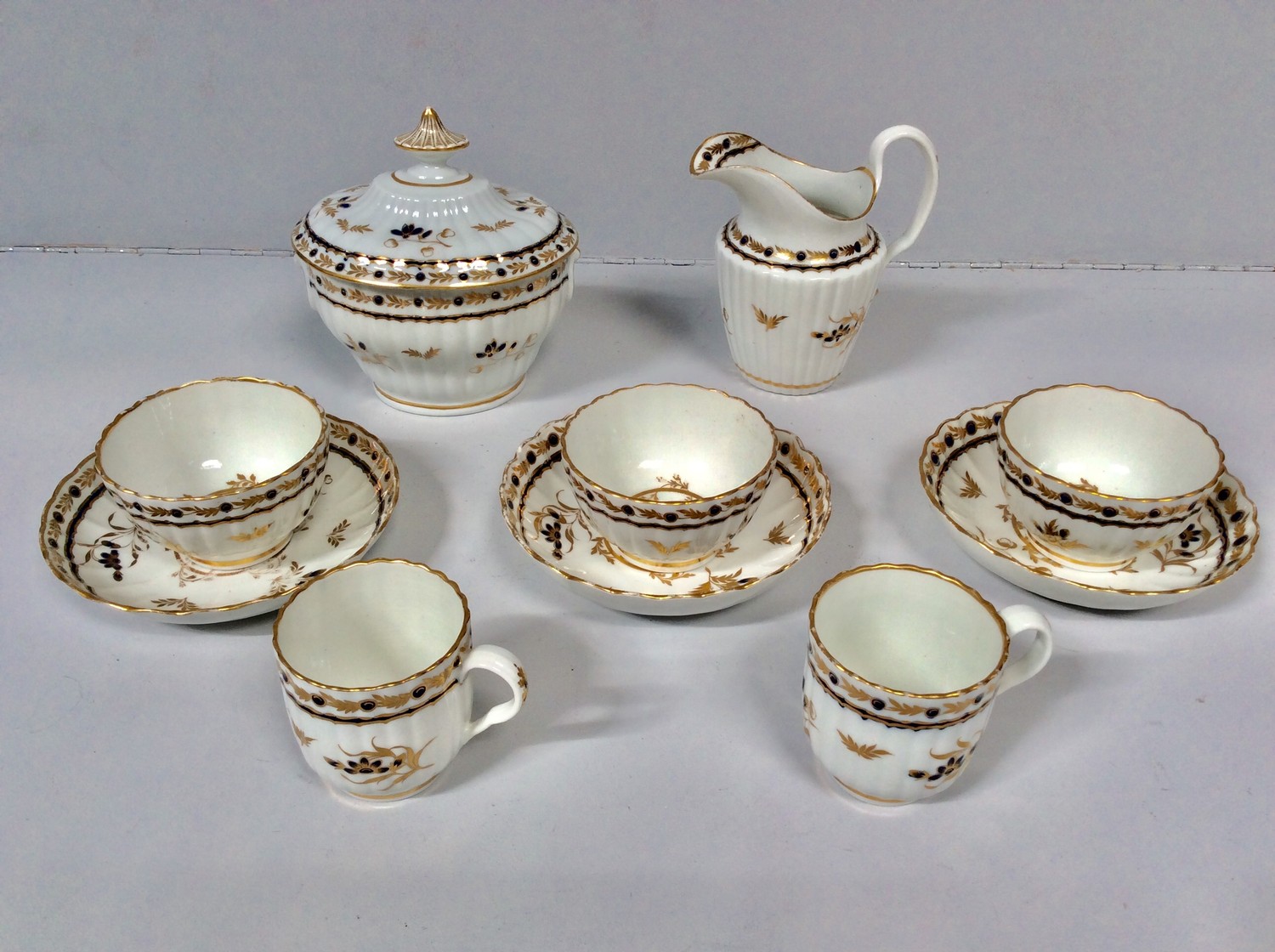 An 18th century Worcester porcelain part tea service decorated with blue and gilt sprigs, to