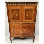 A reproduction Kingwood marquetry French style cocktail cabinet with gilt-metal mounts, glass shelf,