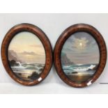 Alan Dinsdale (b.1939) A pair of oval day and night seascape studies with mountains, signed, oils on