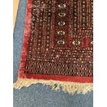 Large Caucasian Hand-knotted in dark red with field of guls within stylised multi-border,