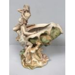 A Royal Dux porcelain figural centrepiece modelled as a conch shell vase mounted with two semi-naked