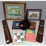 A small collection of militaria including mounted cap badges, a Royal Marines beret, prints and