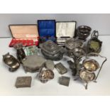 A mixed lot of silver-plated items including jugs, trinket pots, cased flatware, sugar bowls and