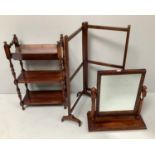 A small mahogany Edwardian bookcase with a trough style top and two shelves on turned supports
