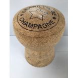 An oversized champagne cork stool inscribed 'Grand Vin De Champagne', approx. 50 high x 35cm wide
