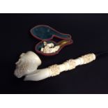 A large meerschaum tobacco pipe with bowl carved as a bearded Turk, 30cm long, together with a small