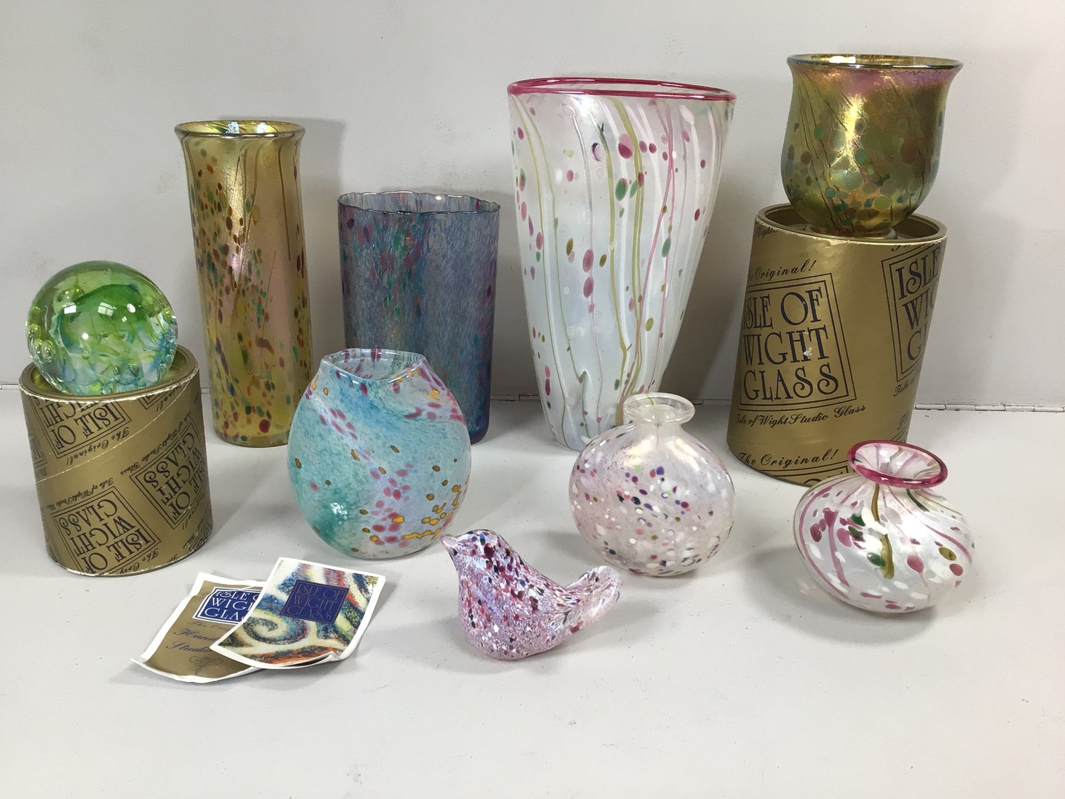 Five various Isle of Wight studio glass vases, together with an Isle of Wight glass bird