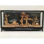 A large Chinese cork carving of miniature buildings, trees, birds and bridges etc. in display