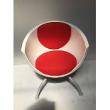 A circa 1990s Ikea curved white plastic chair with red padded seat and back rest, raised on four