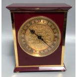 A Swiss Luxor mantel clock with maroon and gilt casing, gilt face and chapter ring with Roman