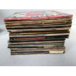 A box of assorted vinyl records including The Beatles, Elvis Presley, Four Tops, Queen, Go West,