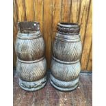A pair of African or South American carved reclaimed wooden cylindrical decorative urns, of