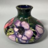 A Moorcroft Pottery vase of compressed globular form decorated in the 'Anemone Tribute' pattern