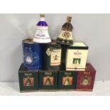 Nine various commemorative Christmas Bells Scotch whisky, housed in Wade ceramic decanters