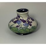 A Moorcroft pottery vase of compressed globular form and decorated in the 'Shrinking Violets'