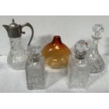 Three various glass decanters including one with silver collar, a ship's style decanter, one with