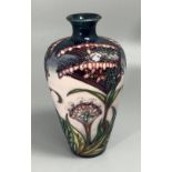 A Moorcroft pottery vase of inverted baluster form, decorated in the 'Gypsy' pattern after Rachel