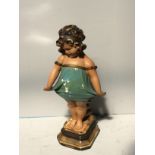 A vintage plaster figure of a bashful girl, raised on shaped pedestal base, 58cm tall