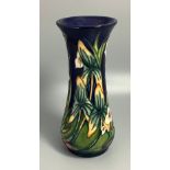 A Moorcroft pottery vase of baluster form with flared rim, decorated in the 'Elphin Beck' pattern