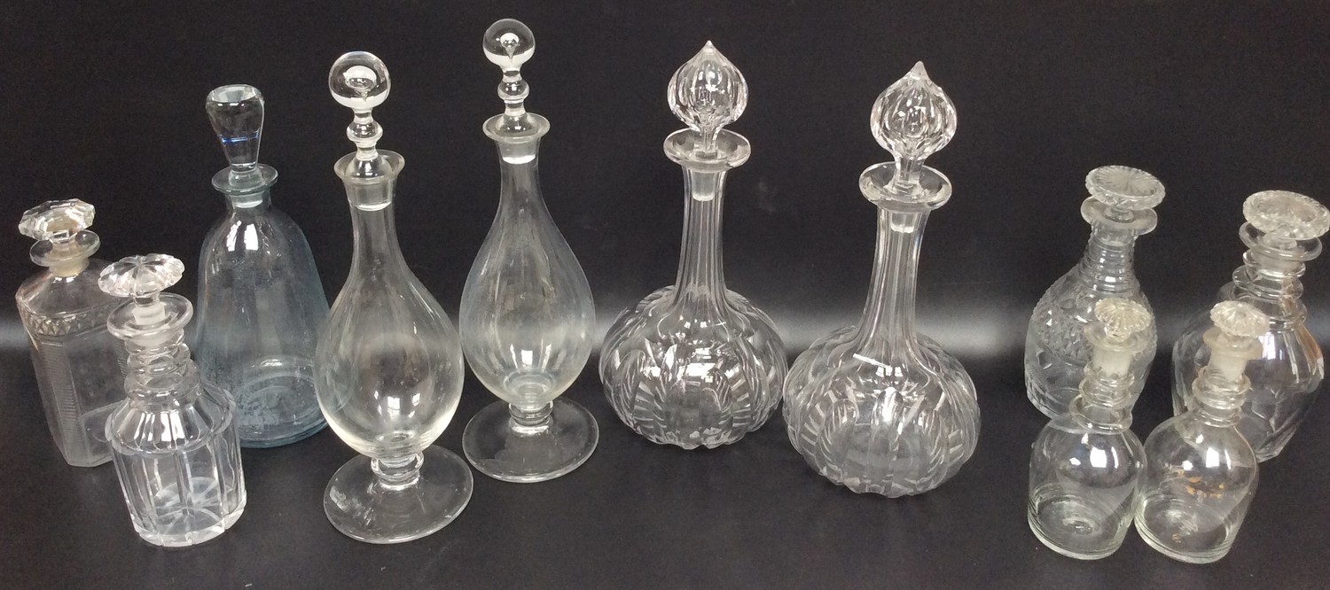 A pair of Victorian cut glass shaft-and-globe decanters with teardrop stoppers, together with a pair