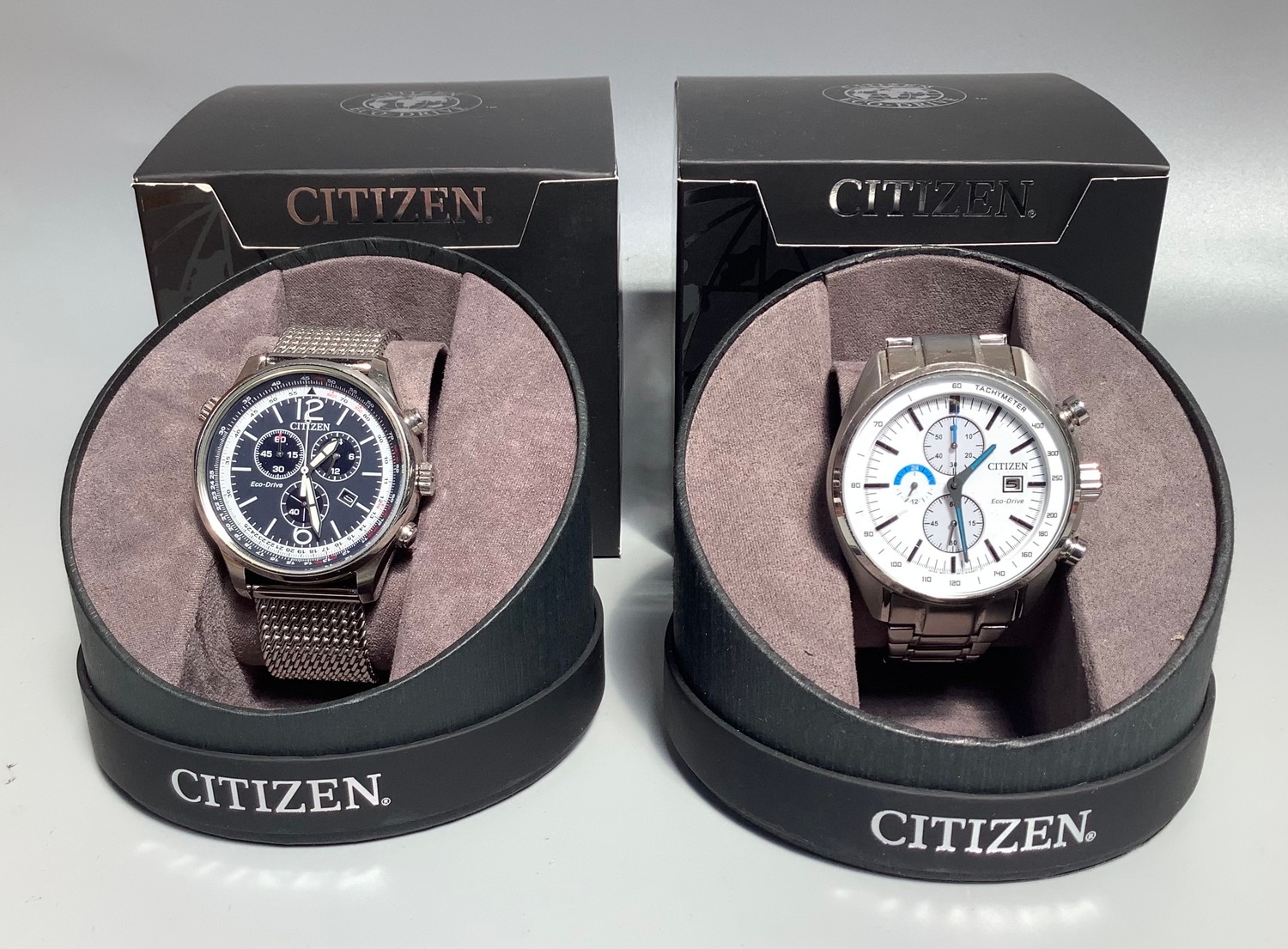 Two gents Citizen Eco-Drives, one with white dial, batons denoting hours, three subsidiary dials and