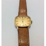 A ladies gold-plated Omega Geneve wristwatch, the gilt dial with batons denoting hours, on tan