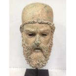 A large bronze bust of a bearded Greek Warrior with helmet, raised on pole and plinth base, 55cm