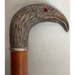 A silver-topped walking stick with silver handle formed as a hawk / bird's head with curved beak and