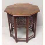 An octagonal middle-eastern wooden occasional table with fretwork foliate carved sides, together