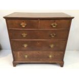 A George III stained oak chest of drawers with two short over three long graduated drawers, with