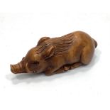 A Japanese Taisho period hand carved boxwood netsuke of a wild boar, signed to base with Himotoshi