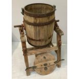 A Waide & Sons of Leeds large oak barrel butter churn, with metal fixings, raised on rustic base, (