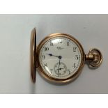 A gold-plated full-hunter pocket watch by Waltham USA, the white enamel dial with Arabic numerals