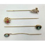 Four various gold stick / tie pins including a 14ct seed pearl modelled as a bunch of grapes with