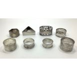 Seven assorted silver napkin rings, gross weight approximately 4.2ozt and one silver-plated example