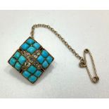 An unmarked 14ct gold, turquoise and diamond brooch, of square form with central cross of nine