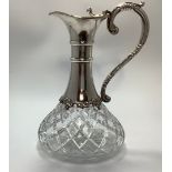 A Queen Elizabeth II silver-mounted cut glass claret jug, with hinged silver cover, swan neck handle