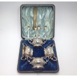 A cased set of four Edwardian silver salts, Walker & Hall, of two-handled oval form embossed with