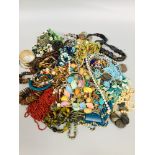 A large selection of costume jewellery including strings of beads, earrings and various bracelets.