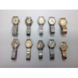 A collection of ten assorted gents stainless steel and gold-plated Ingersoll wristwatches, housed in