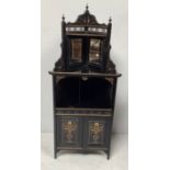 An aesthetic movement ebonised and gilt highlighted corner cupboard with shaped fretwork top, pair