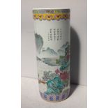 An Chinese porcelain stick stand of cylindrical form painted in polychrome enamels with mountain